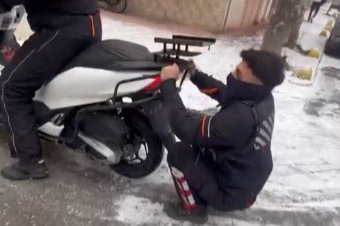 Kurye, buzlu zeminde kayarak eğlendi